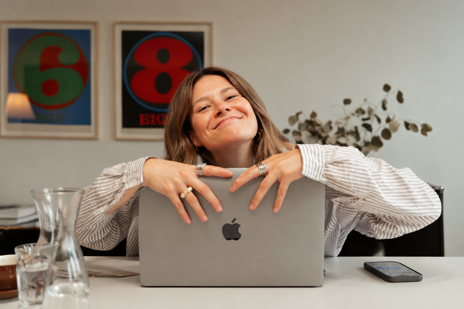 Sofia M. smiling behind her laptop